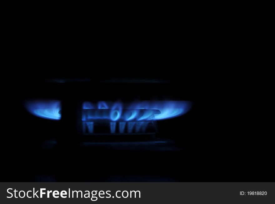 The gas burns with a blue flame on the oven.