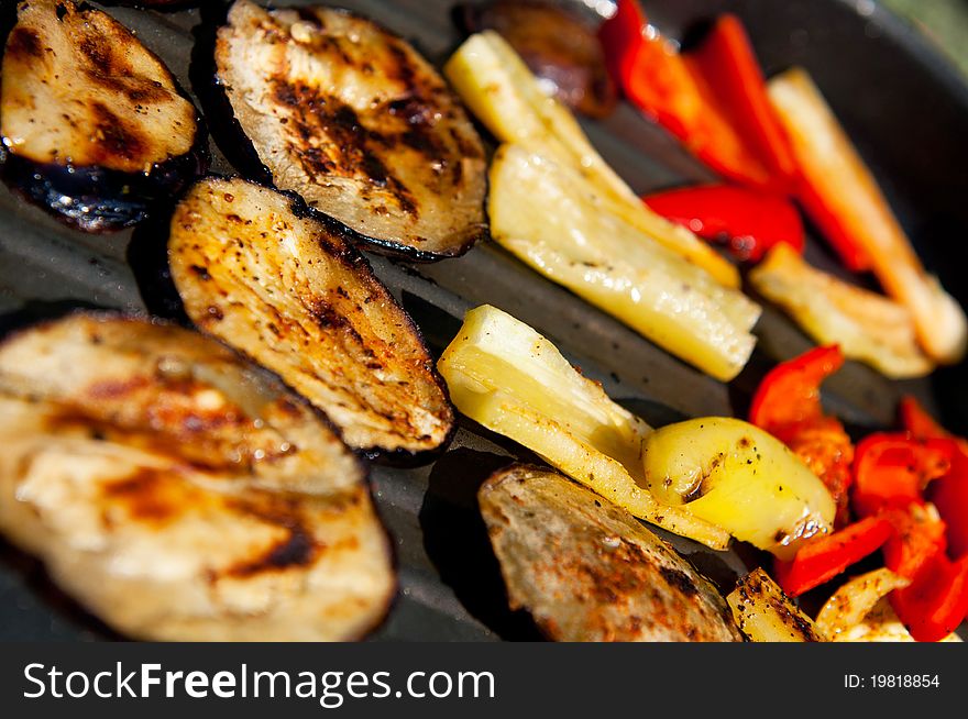 Grilled peppers and eggplants on a griddle.