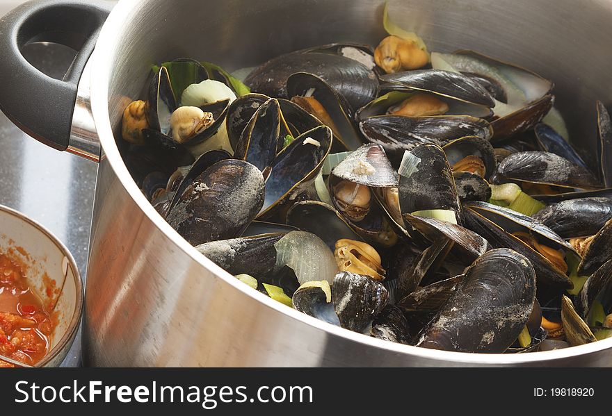 Cooked mussels in a big pan