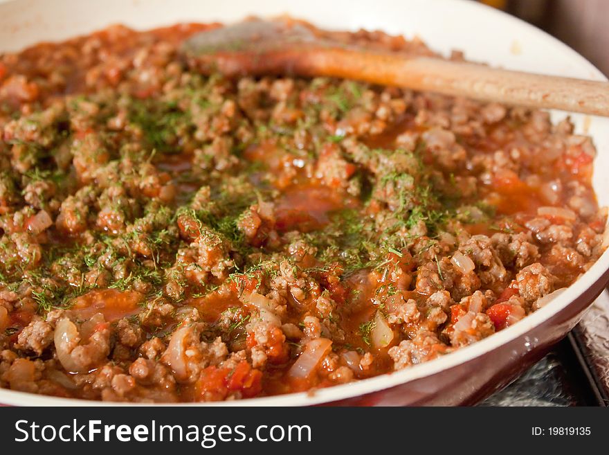 Minced meat cooking in the pan with chopped onions. Minced meat cooking in the pan with chopped onions
