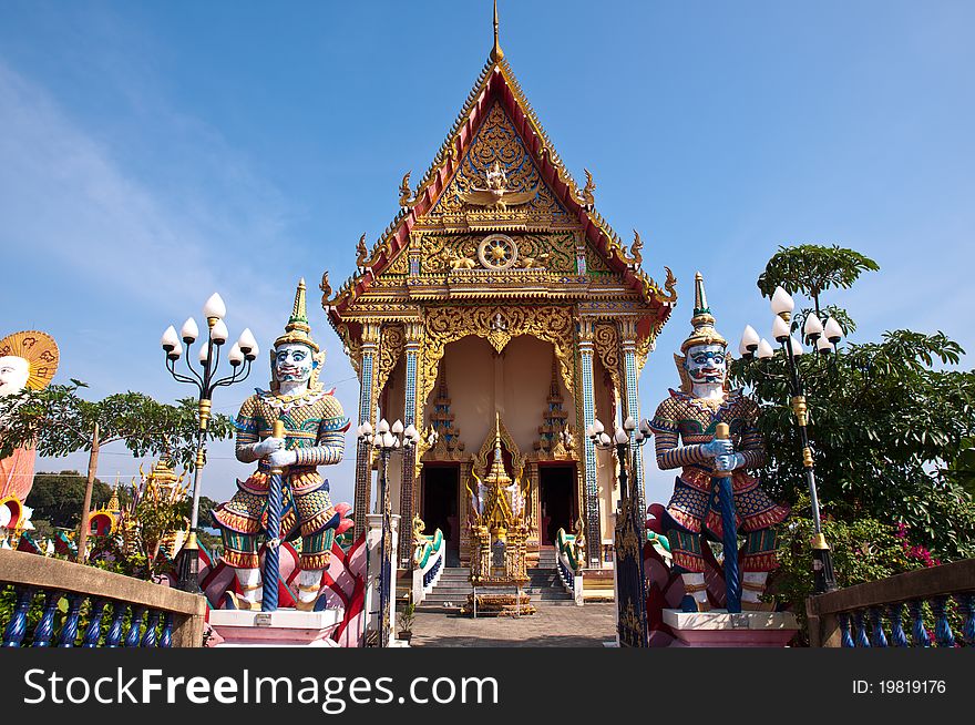 Thai temple with giant at the gate with clear sky background