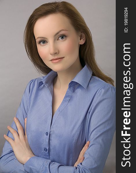 Portrait of young business woman with chestnut hair and in dark blue blouse. Portrait of young business woman with chestnut hair and in dark blue blouse