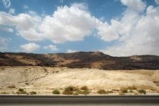 Stone Desert And Mountains Along The Road Royalty Free Stock Image
