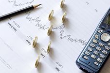 Stock Chart With A Pencil, A Telephone And Coins Stock Images