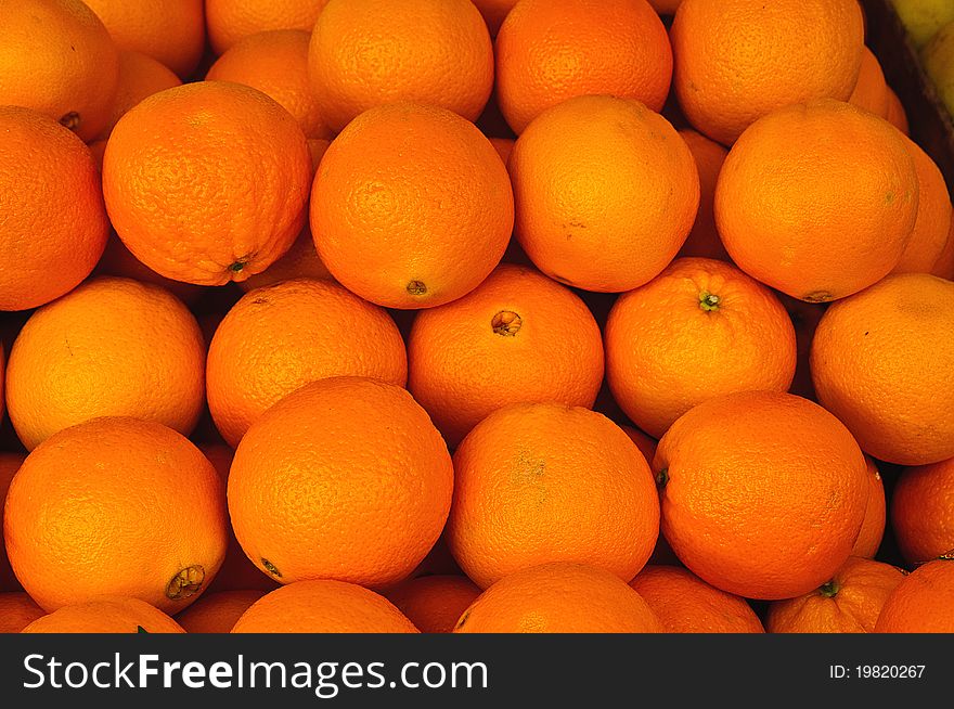 Pile of fresh juicy Oranges in market stand