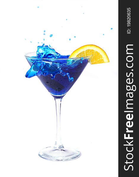 Blue cocktail with splashes and orange