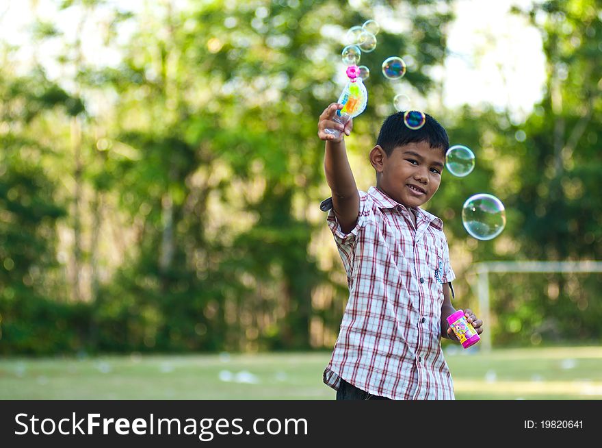 Asian Boy Playing Balloon Gun Toy