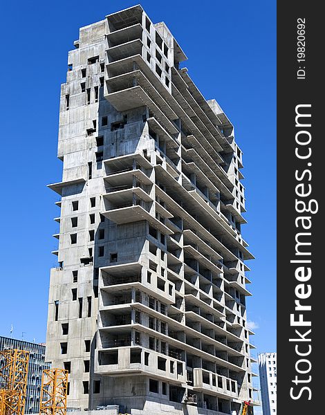 Construction of a monolithic high-rise buildings against the blue sky. Construction of a monolithic high-rise buildings against the blue sky.