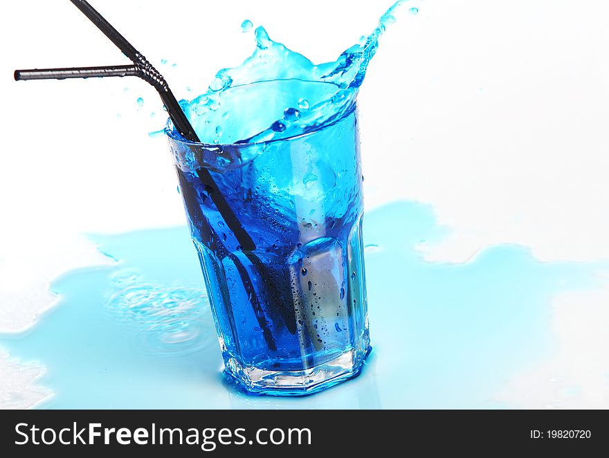 Fruit blue cocktail with splashes isolated on white