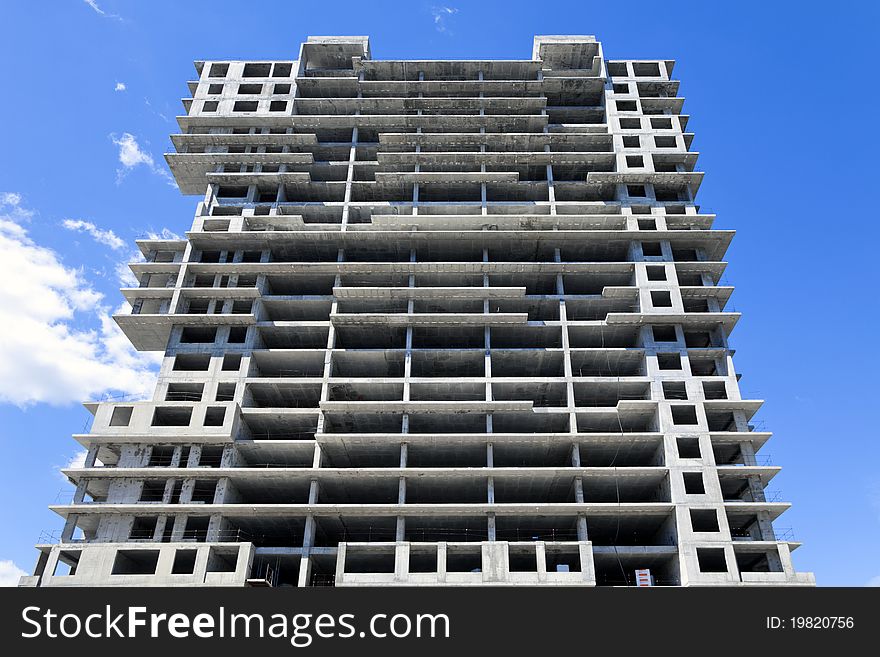 Construction of a monolithic high-rise buildings against the blue sky. Construction of a monolithic high-rise buildings against the blue sky.