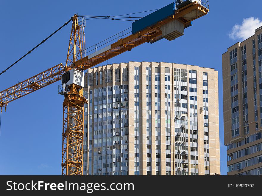 Construction crane on the background buildings. Construction crane on the background buildings.