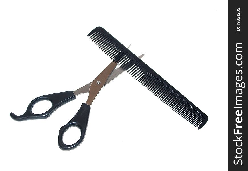 Scissors and comb on a white background