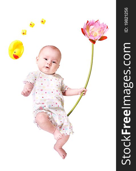 A baby with a big flower and some toy ducks isolated on the white background. A baby with a big flower and some toy ducks isolated on the white background