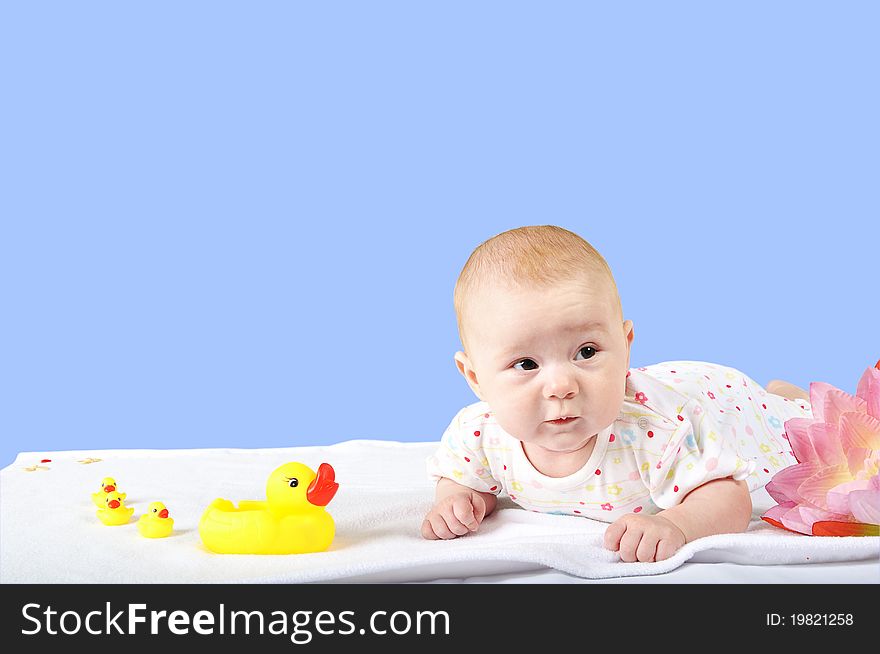 A baby with yellow toy duck and ducklings isolated