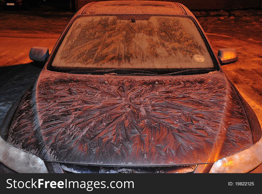 Shot of a car in extreme cold weather with interesting ice fronds formed on the bonnet shot under sodium lighting. Shot of a car in extreme cold weather with interesting ice fronds formed on the bonnet shot under sodium lighting