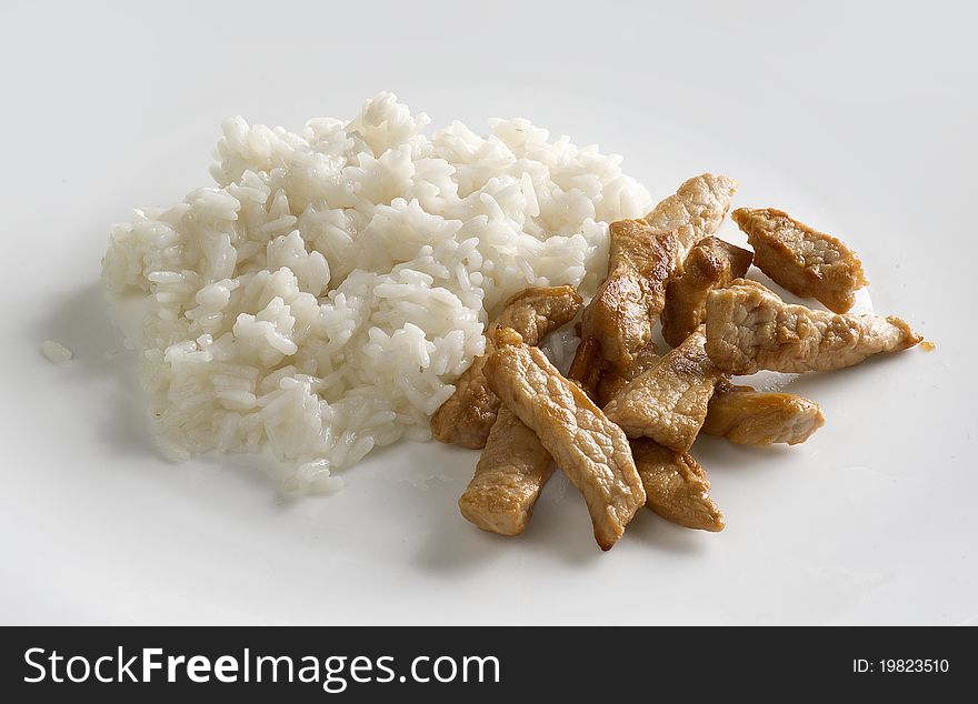 Pork goulash with rice on the gray plate