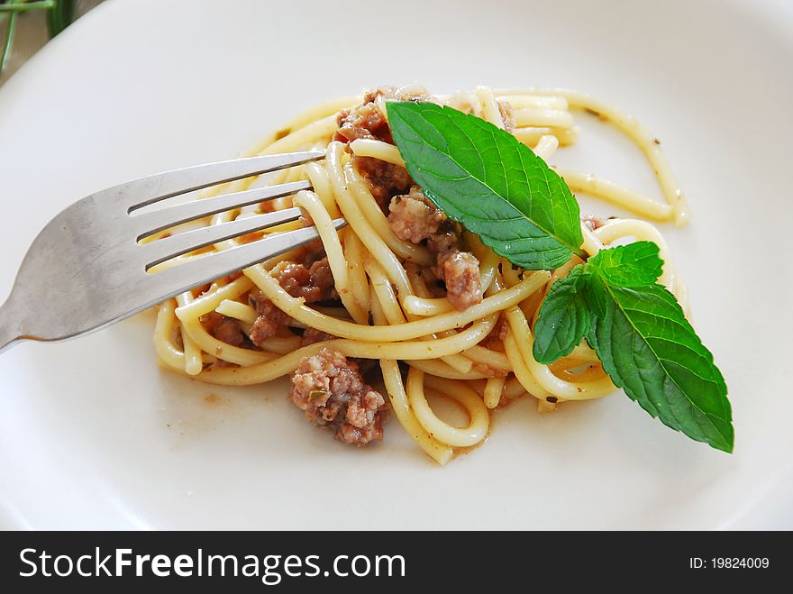 Small portion of spaghetti mixed with minced meat served on white plate. Small portion of spaghetti mixed with minced meat served on white plate