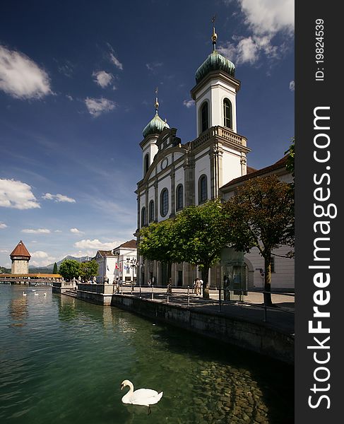 The Jesuit Church of Lucerne, Switzerland, with the tower of the Chapel Bridge in the distance. The Jesuit Church of Lucerne, Switzerland, with the tower of the Chapel Bridge in the distance.