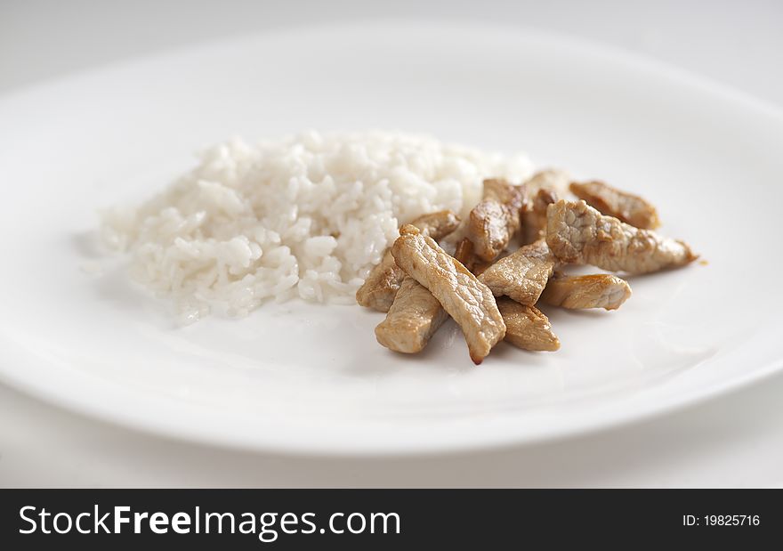 Pork goulash with rice on the gray plate