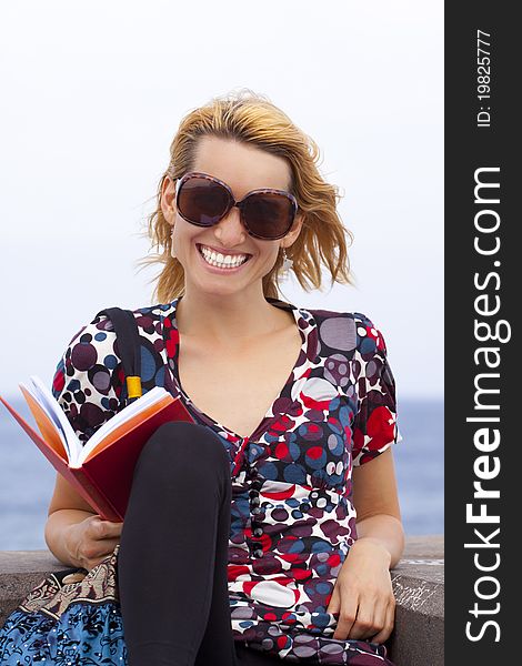 Attractive young lady reading a book.