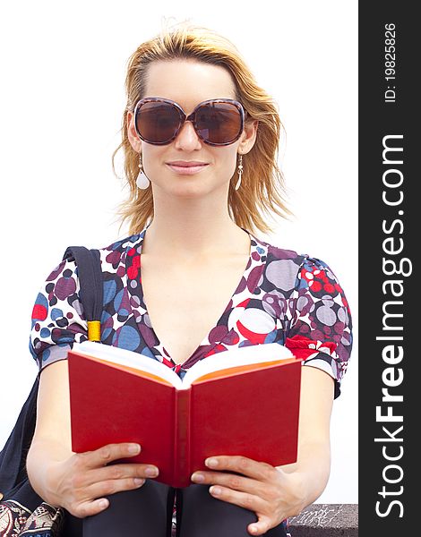 Attractive young lady reading a book.