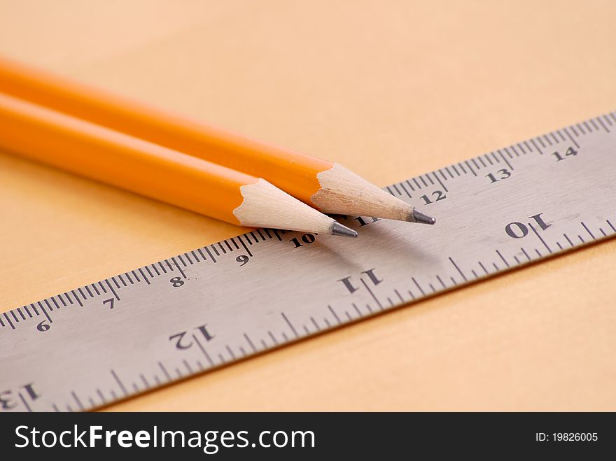 Two Sharpened Pencils On Metal Ruler. Two Sharpened Pencils On Metal Ruler