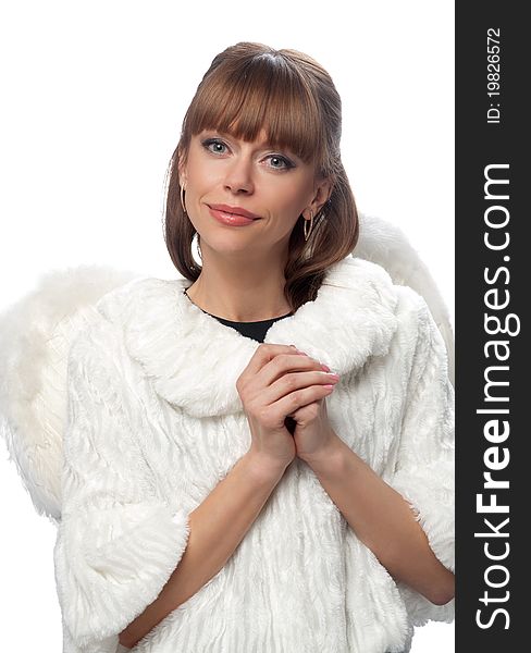 Portrait of a woman brunette in a white coat and wings on the isolated background. Symbolizes an angel.