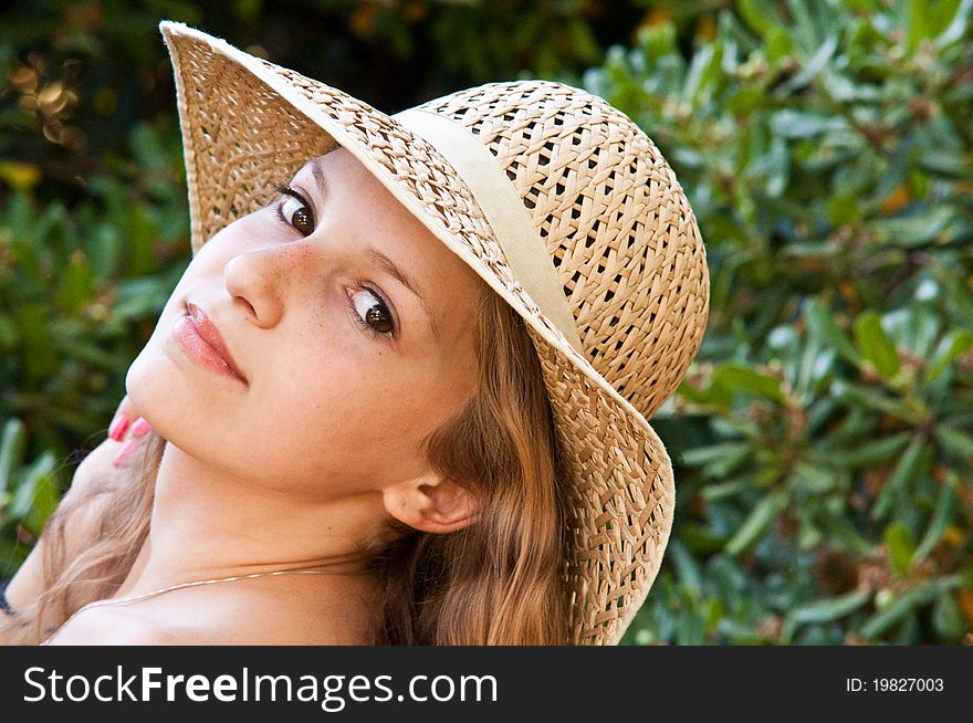 Portrait of teen girl in a straw hat. Portrait of teen girl in a straw hat.