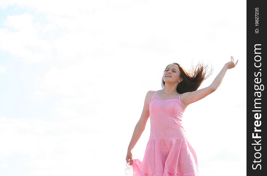 Girl with eyes closed against the sky