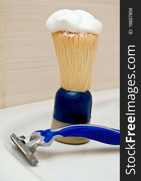 Razor and shaving brush in the bathroom