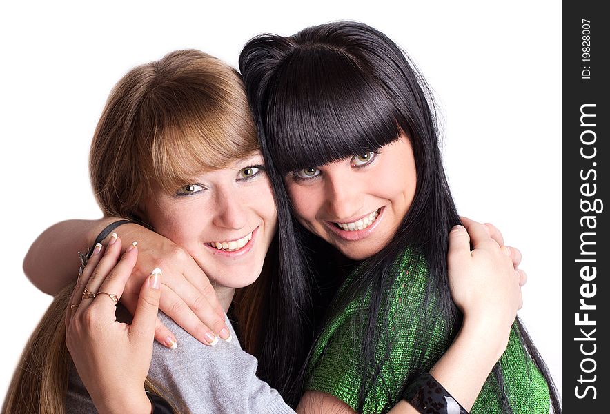 Two smiling girl-friends isolated on the white