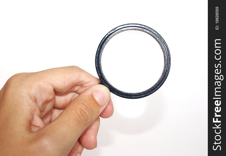 Hand with magnifying glass on a white background