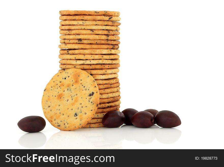 Olive cracker biscuit stack with fresh black kalamata olives isolated over white background. Olive cracker biscuit stack with fresh black kalamata olives isolated over white background.