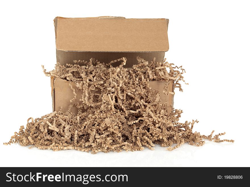 Cardboard shipping box with recycled brown paper protective filler, isolated over white background. Cardboard shipping box with recycled brown paper protective filler, isolated over white background.