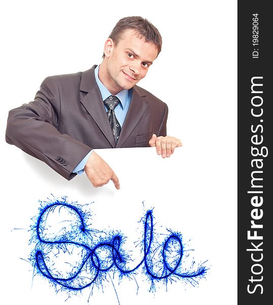 Young businessman points his finger at the white background with the words SALE