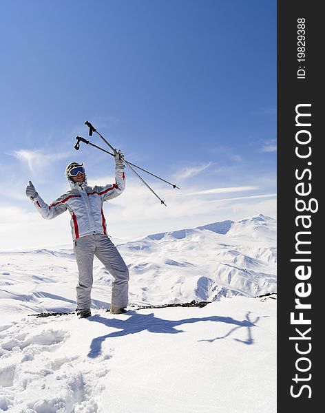 Happy beautiful skier posing on the top of mountain Ejder. Palandoken. Happy beautiful skier posing on the top of mountain Ejder. Palandoken