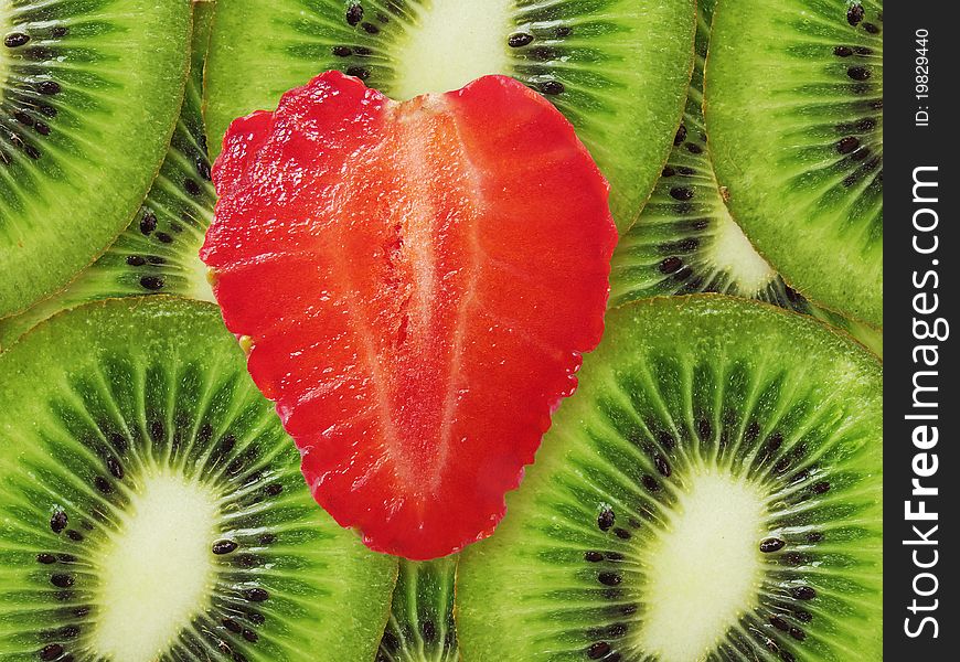 Strawberry in a kind heart against kiwi. Red and green. Strawberry in a kind heart against kiwi. Red and green.