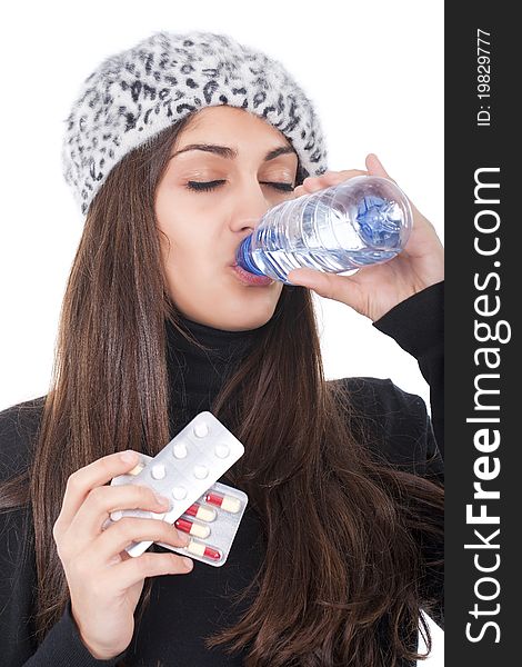Young woman taking some pills with a bottle of water. Young woman taking some pills with a bottle of water