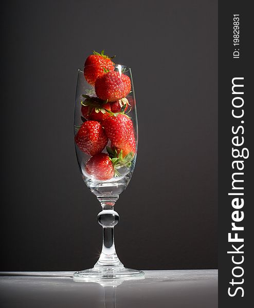 Tasty strawberries in a glass on black background. Tasty strawberries in a glass on black background