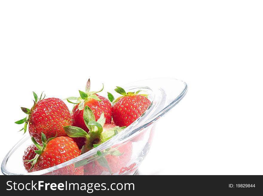 Tasty strawberries in a bowl on white background