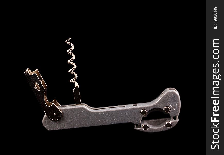 Bottle opener with screw, isolated towards black background