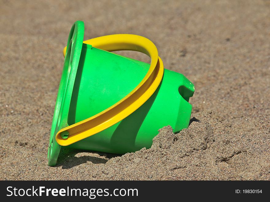 Plastic toy bucket. placed in a sandbox