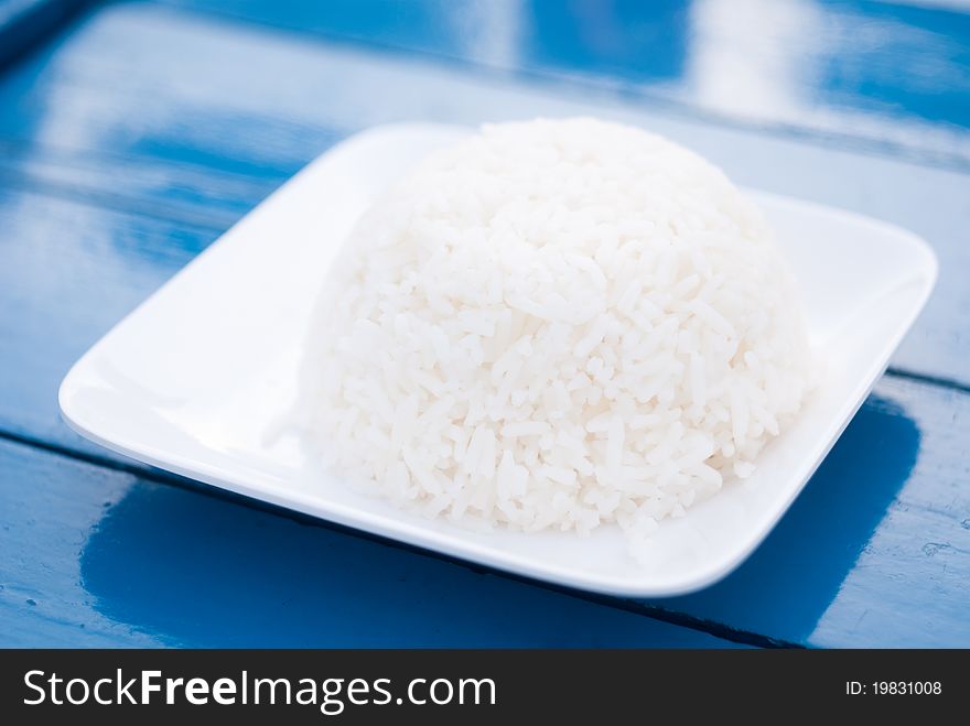 Thai rice on plate in blue background, Close up shot.