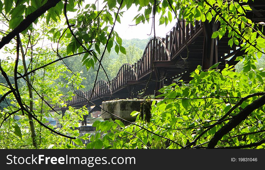 A pedestrian bridge as seen from a hiking trail. A pedestrian bridge as seen from a hiking trail