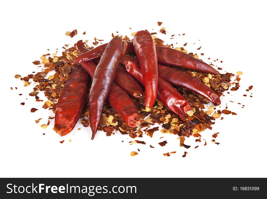 Dried red peppers and flakes, isolated on white.