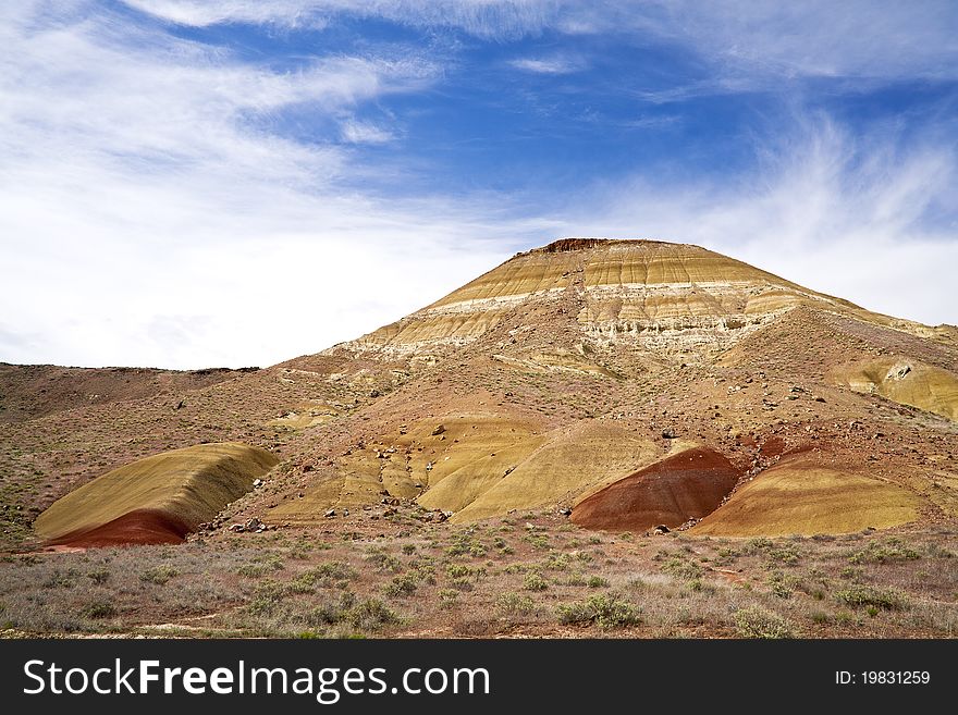 A section of the painted hills under a bright blue sky. A section of the painted hills under a bright blue sky.