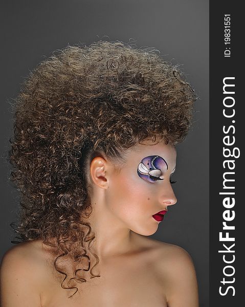 Portrait of beautiful girl with curly coiffure on grey. Portrait of beautiful girl with curly coiffure on grey