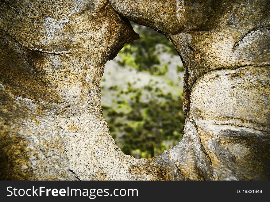 A rock high in the Clear Creek mountain range where wind has for years funnelled thru a draw to bore a hole thru a rock. A rock high in the Clear Creek mountain range where wind has for years funnelled thru a draw to bore a hole thru a rock.