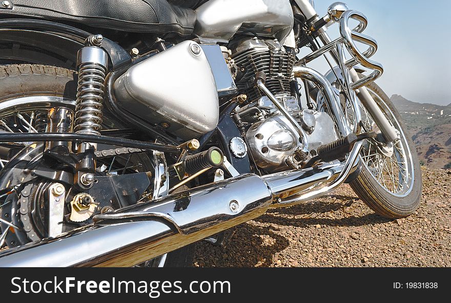 Motorbike detailing, close up, parked edge of cliff, india, horizontal, mountains background. Motorbike detailing, close up, parked edge of cliff, india, horizontal, mountains background