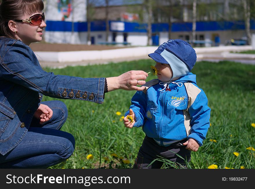 Photo of the Mother and son through dandelions